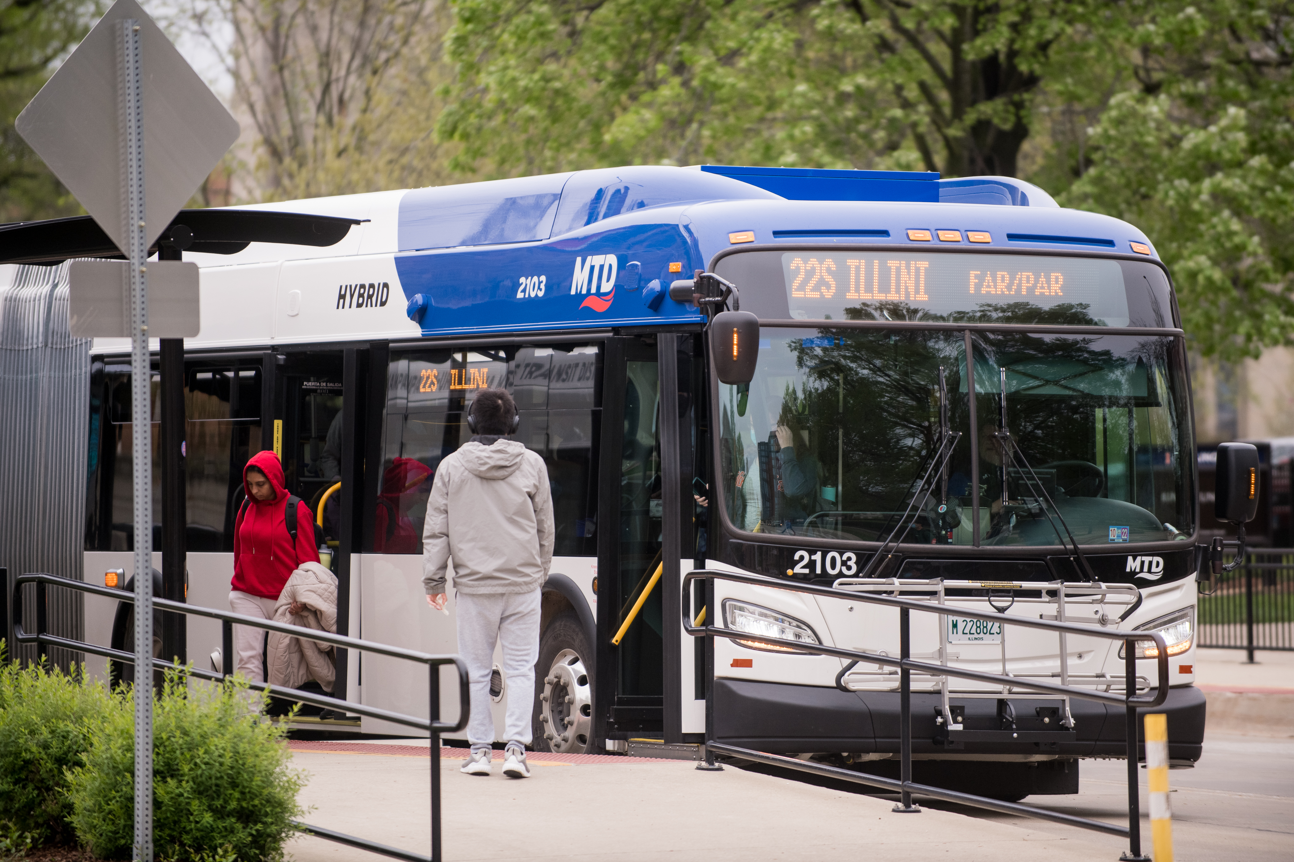 Passengers boarding and alighting one of MTD's low emission hybrid buses; their entire fleet is now low and zero emission. MTD's last diesel buses retired in May 2023.